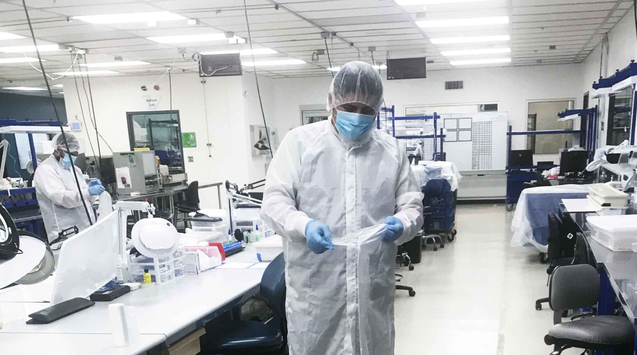 Technician in protective gear performing cleanroom sanitization, part of Transcend Maintenance specialized disinfection and commercial cleaning services.