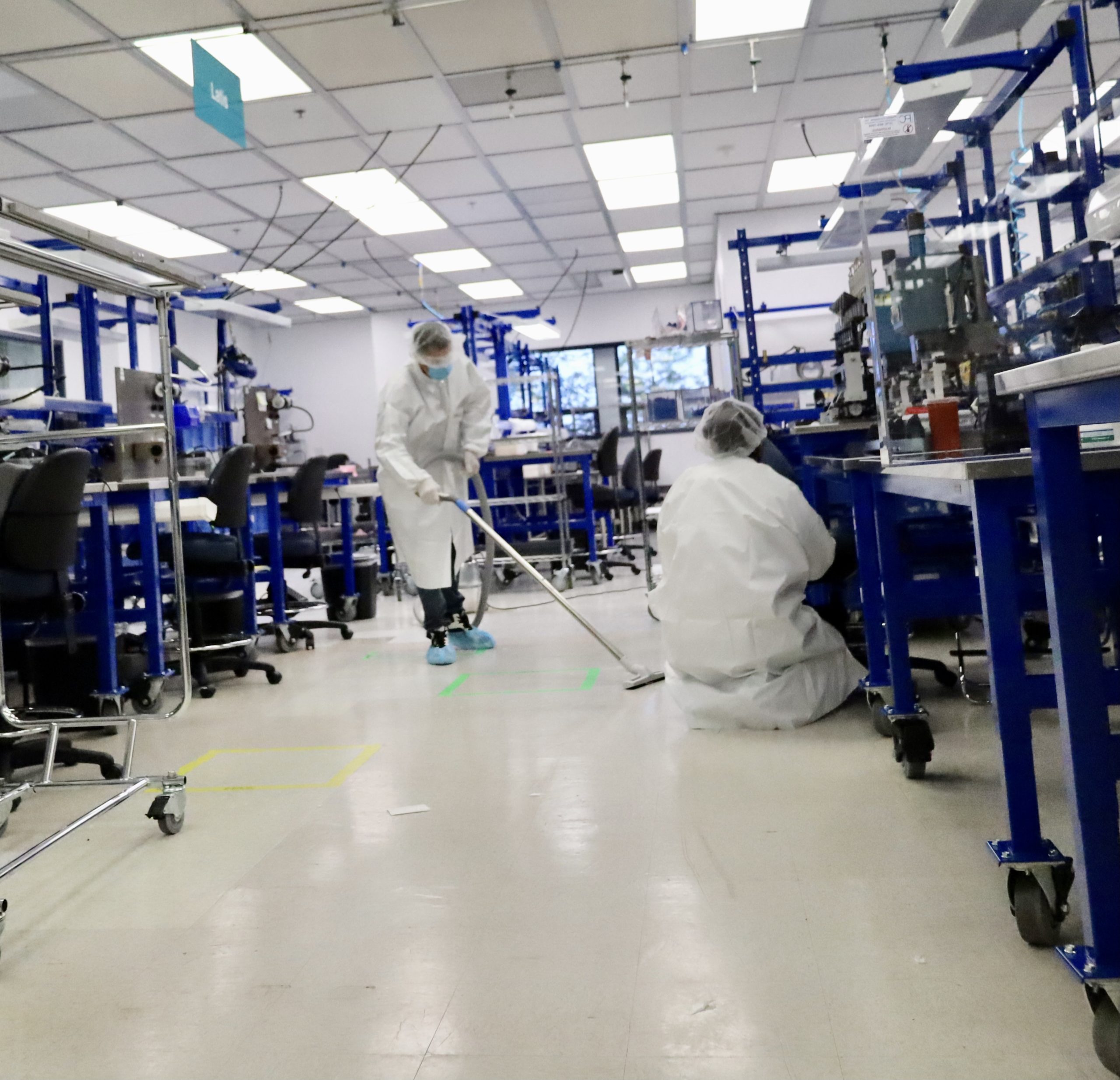 Transcend Maintenance staff cleaning and disinfecting a cleanroom facility with specialized equipment to maintain contamination-free environments.