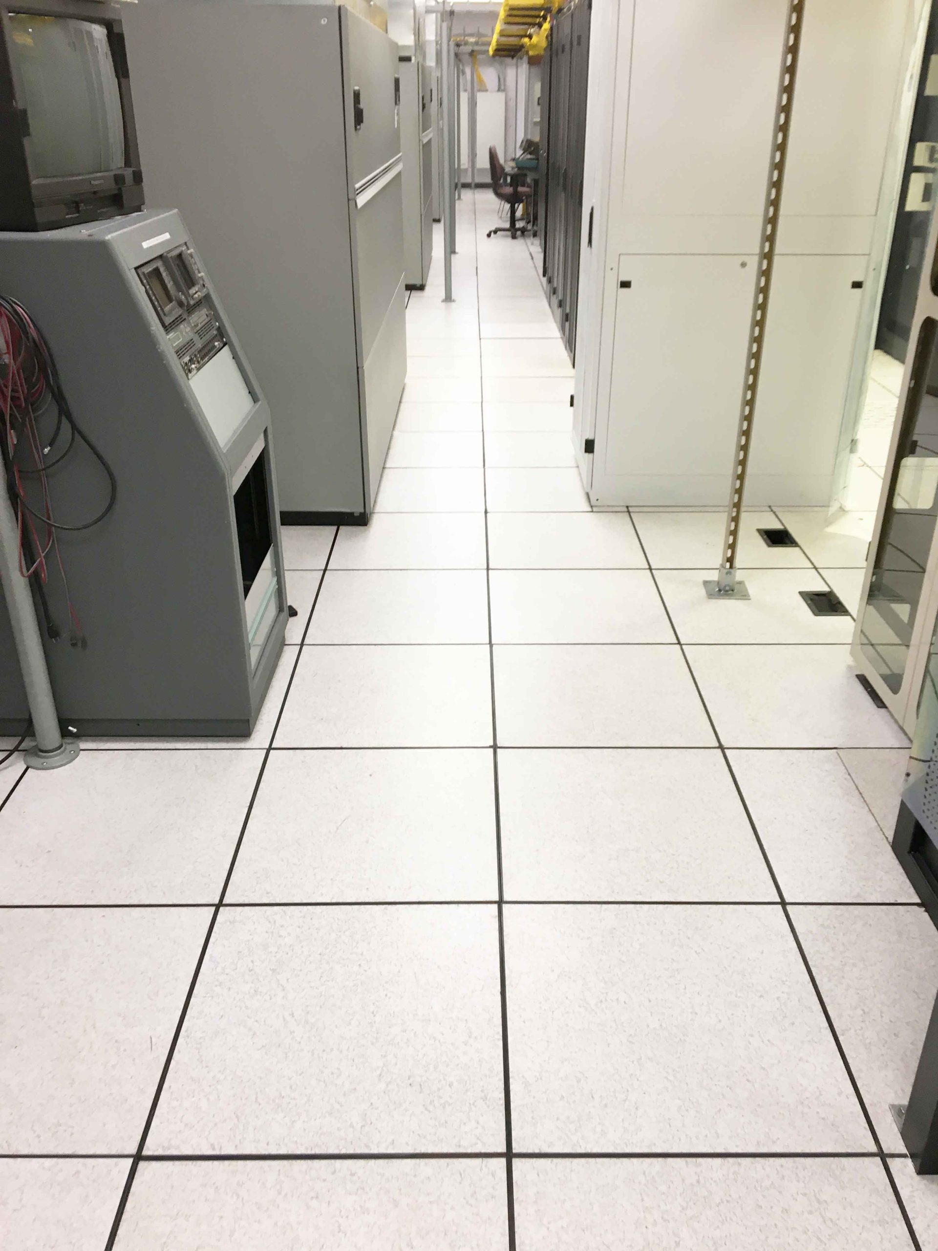 Clean data center room with polished tile floors and organized server racks maintained through specialized janitorial services.