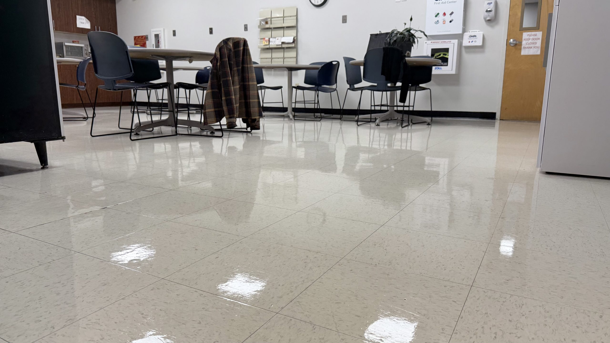 Freshly cleaned and polished breakroom floor in a commercial facility, maintained by professional janitorial services in Massachusetts.