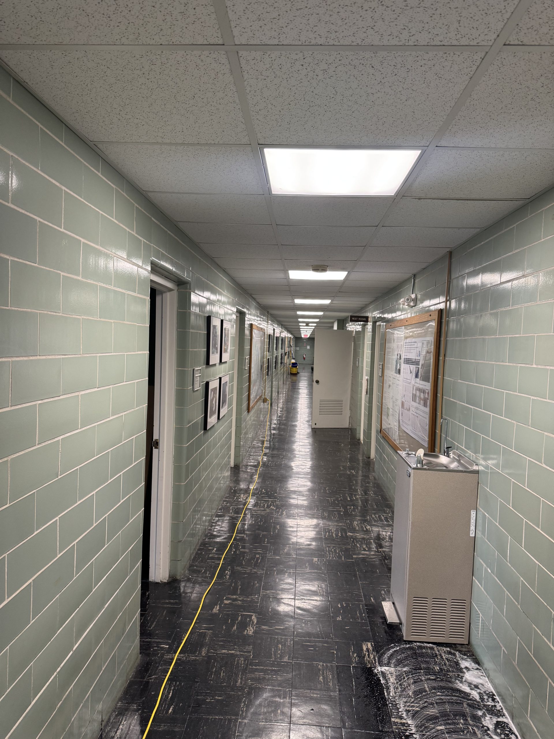 Clean industrial facility hallway with polished floors and bright lighting maintained by Transcend Maintenance Services.