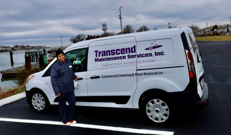 A Transcend Maintenance Services team member standing beside the branded company van used for commercial cleaning and floor restoration services.
